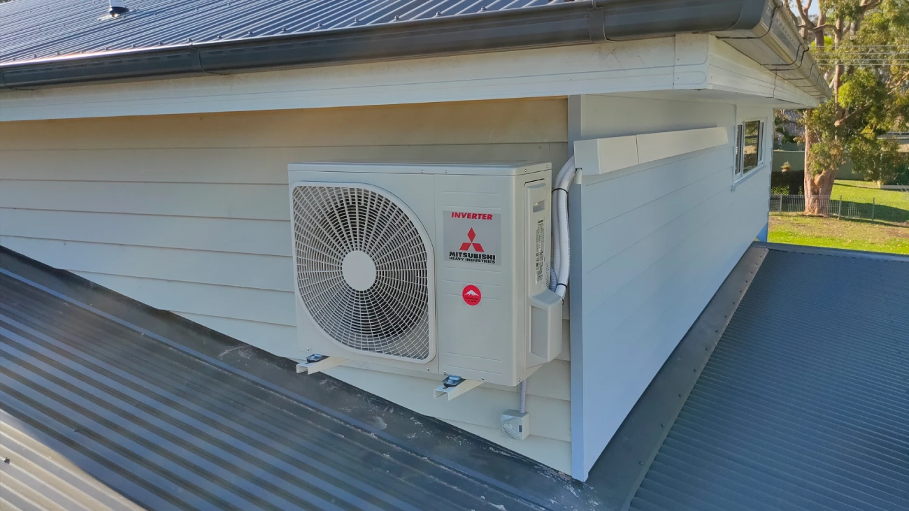 a new Mitsubishi heavy industries split system on the side of a houe